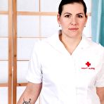 Pic of Brunette nurse Sharlyn spreads her hairy twat in white nylons and garters