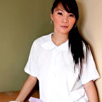 Pic of Asian teen Carla touches her breasts and pussy in over the knee socks