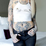 Pic of Tattooed girl Leigh Raven wears a black choker while getting naked