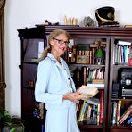 Pic of Classy mature granny strips off her suit to toy her pussy in the library