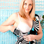 Pic of Middle-aged lady Tonya gets naked on top of her bed in heels