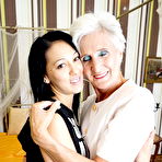 Pic of Horny granny and her teen lover kiss before lesbian sex commences