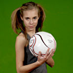Pic of Petite girl Kelly exposes a breast while holding a soccer ball